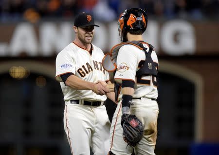 Oct 25, 2014; San Francisco, CA, USA; San Francisco Giants catcher Buster Posey (28) shakes hands with relief pitcher Hunter Strickland (left) after defeating the San Francisco Giants during game four of the 2014 World Series at AT&T Park. Mandatory Credit: Christopher Hanewinckel-USA TODAY Sports