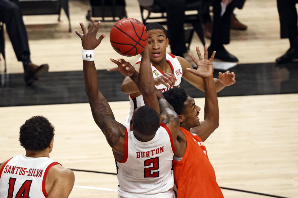 Texas Tech's Jamarius Burton (2) and Sam Houston State's Terryonte Thomas (5) vie for a rebound during the first half of an NCAA college basketball game Friday, Nov. 27, 2020, in Lubbock, Texas. (AP Photo/Brad Tollefson)