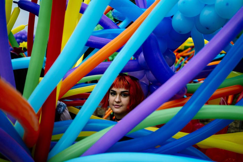 <p>A participant looks through balloons during the 11th Gay Pride Parade in downtown Sofia on June 9, 2018, as gays, lesbians and transsexuals march through Bulgarian capital to protest against discrimination against homosexuals and improve their integration in the society. (Photo: Dimitar Dilkoff/AFP/Getty Images) </p>