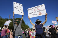 FILE - Protesters hold signs in Portland, Ore., about the Supreme Court's decision overruling Roe v. Wade, June 24, 2022. Reproductive freedom was not the only demand of second-wave feminism, as the women's movement of the '60s and '70s is known, but it was surely one of the most galvanizing issues, along with workplace equality. (AP Photo/Craig Mitchelldyer, File)