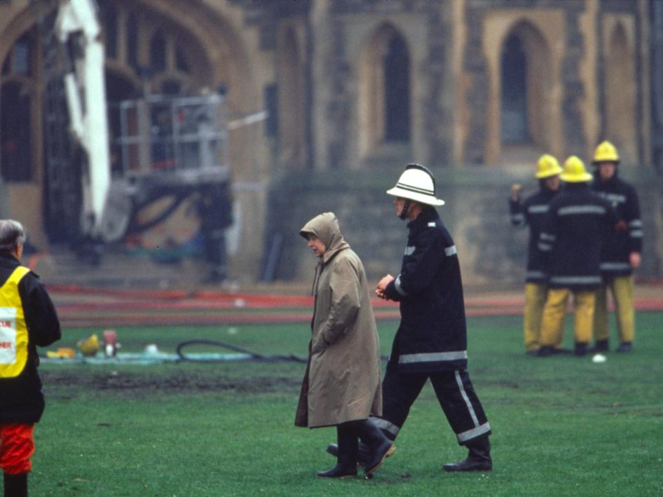 The Queen arrived at Windsor Castle and joined the "human chain" to salvage what was left.