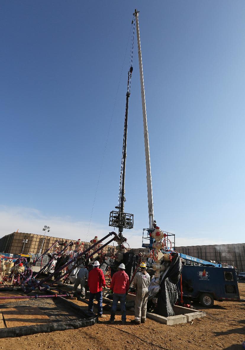 In this March 25, 2014 photo, perforating tools, used to create fractures in the rock, are lowered into one of six wells during a roughly two-week hydraulic fracturing operation at an Encana Corp. well pad near Mead, Colo. Proponents of hydraulic fracturing point to the economic benefits from vast amounts of formerly inaccessible hydrocarbons that now can be extracted with hydraulic fracturing. Opponents point to potential environmental impacts, with some critics acknowledging that some fracking operations are far cleaner than others. (AP Photo/Brennan Linsley)