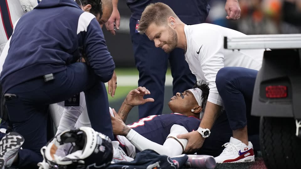 Dell is attended to after being injured in the first half against the Broncos. - Eric Gay/AP