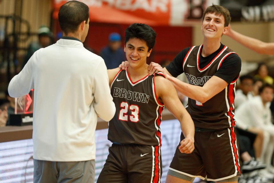 Brown's Kimo Ferrari prepares to hug head coach Mike Martin after he had scored a career-high 39 points against Dartmouth on Saturday.