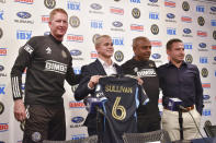 Philadelphia Union manager Jim Curtin, from left, new player Cavan Sullivan, 14, reserve team coach Marlon LeBlanc, and academy director Jon Scheer pose for a photo as Sullivan holds up his new No. 6 jersey during an MLS soccer news conference at Subaru Park in Chester, Pa., Thursday, May 9, 2024. (Jonathan Tannenwald/The Philadelphia Inquirer via AP