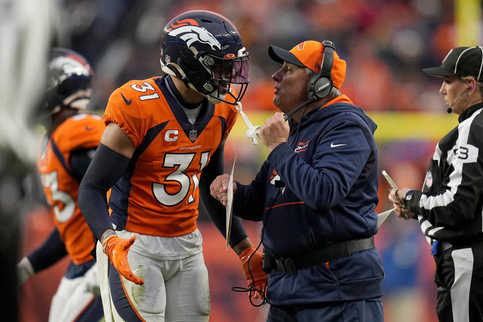 Denver Broncos free safety Justin Simmons (31) talks with head coach Vic Fangio during the second half of an NFL football game against the Washington Football Team , Sunday, Oct. 31, 2021, in Denver. (AP Photo/Jack Dempsey)