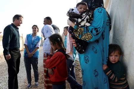 Prime Minister David Cameron meets a Syrian refugee family in a settlement camp in the Bekaa Valley in Lebanon, September 14, 2015. REUTERS/Stefan Rousseau/Pool