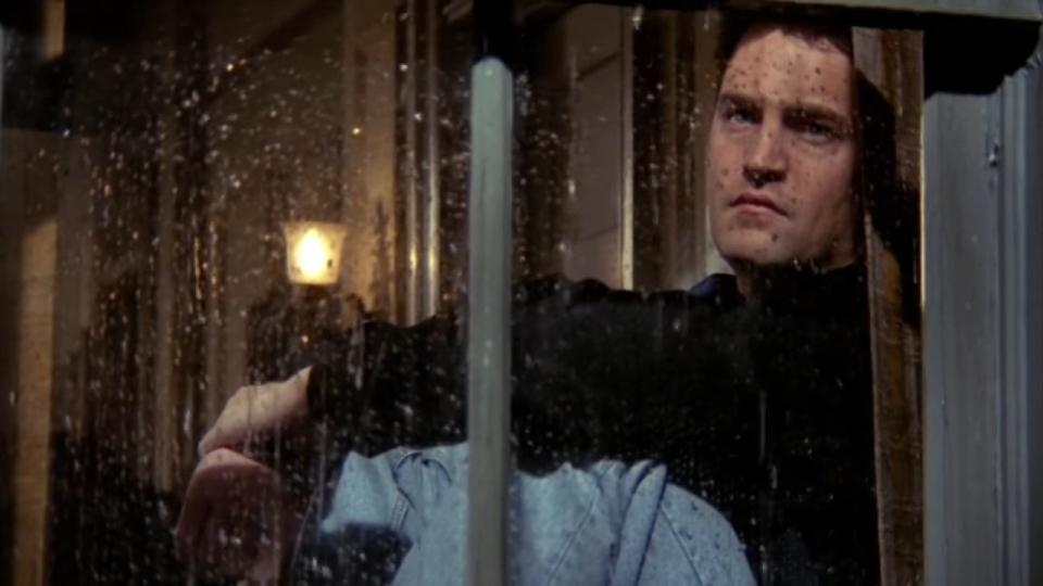 Chandler staring out a rainy window in "Friends"