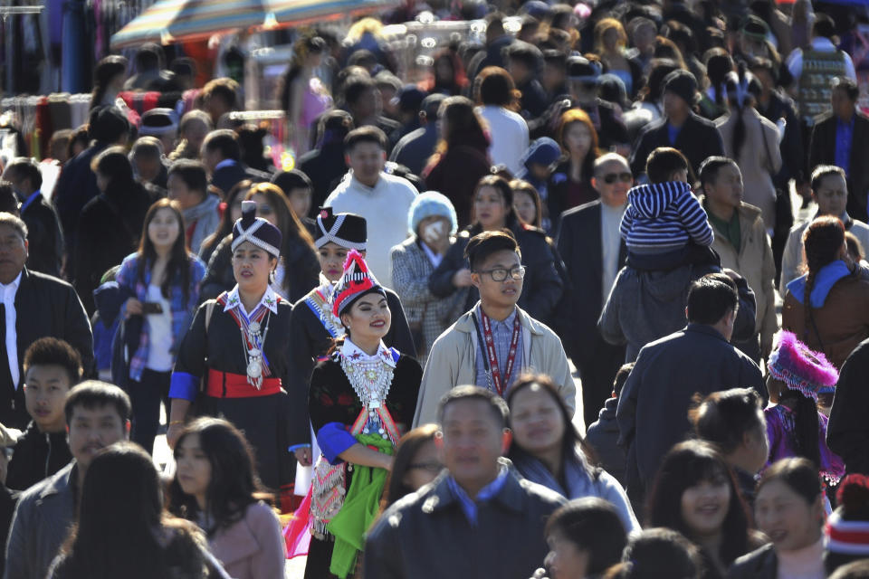 In this photo taken Dec. 26, 2016, thousands filled the fairgrounds for the first day of the Hmong International New Year in Fresno, Calif. The country's small Hmong American population is reeling from the shooting deaths of four men at a backyard party at a Northern California central valley city. Fresno hosts a week-long New Year's party every year that draws tens of thousands of Hmong from around the country, complete with colorful traditional dress, song, and sports games. (John Walker/The Fresno Bee via AP)