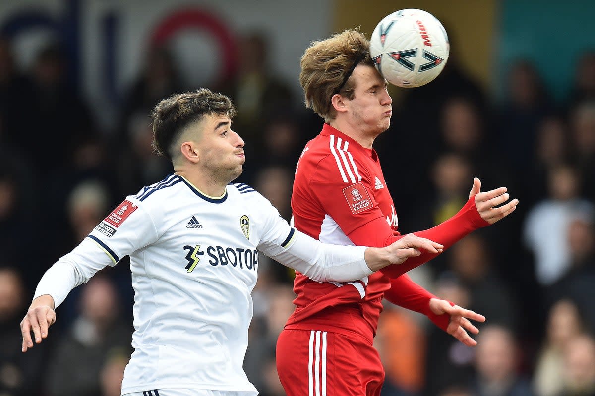 Leeds United's Spanish midfielder Marc Roca (L) vies to header the ball against Accrington Stanley's English midfielder Tommy Leigh (AFP via Getty Images)