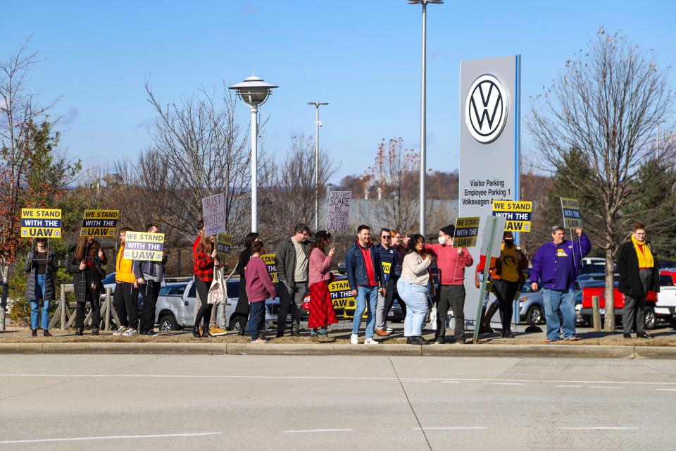 A group walks away from the Volkswagen plant with their signs in Chattanooga, Tenn., on Monday, Dec. 18, 2023. UAW President Shawn Fain visited the plant with Volkswagen workers, community and faith leaders, and CALEB (Chattanoogans in Action for Love, Equality, and Benevolence). The group delivered a letter to Volkswagen management, "demanding the company end its union-busting and intimidation."