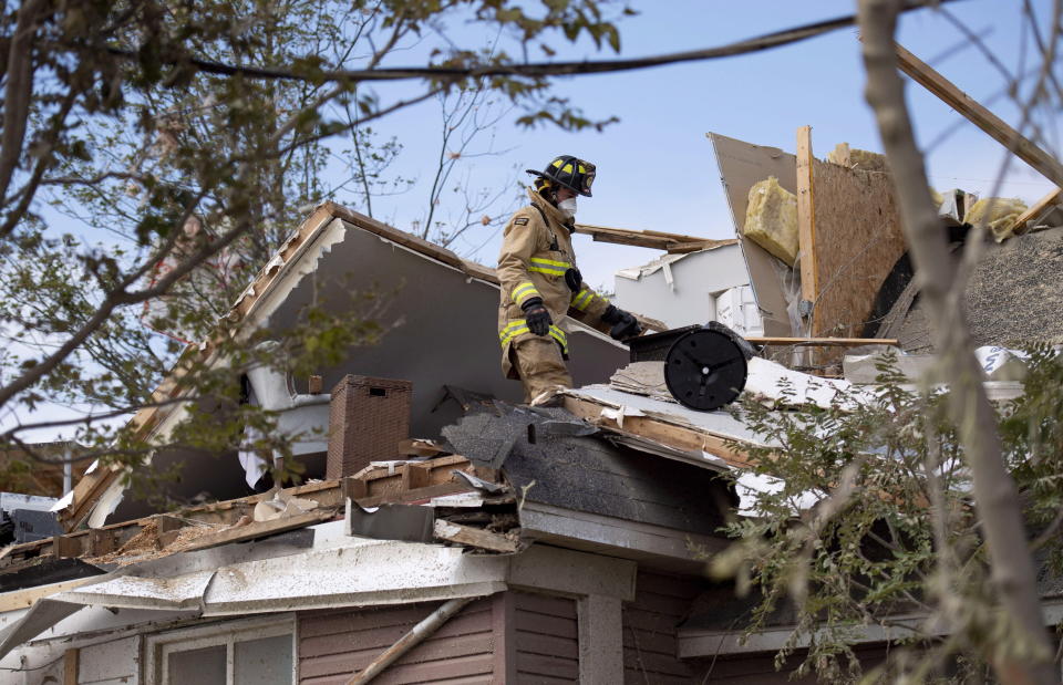 <p>An Ottawa firefighter searches for personal items belonging to residents in a home damaged by a tornado in Dunrobin, Ont., west of Ottawa, on Sunday, Sept. 23, 2018. The storm tore roofs off of homes, overturned cars and felled power lines in the Ottawa community of Dunrobin and in Gatineau, Que. (Photo from Justin Tang/The Canadian Press) </p>