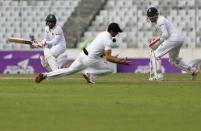 Cricket - Bangladesh v England - Second Test cricket match - Sher-e-Bangla Stadium, Dhaka, Bangladesh - 28/10/16. England's captain Alastair Cook takes a catch to dismiss Bangaldesh's captain Mohammad Rahim (L). REUTERS/Mohammad Ponir Hossain