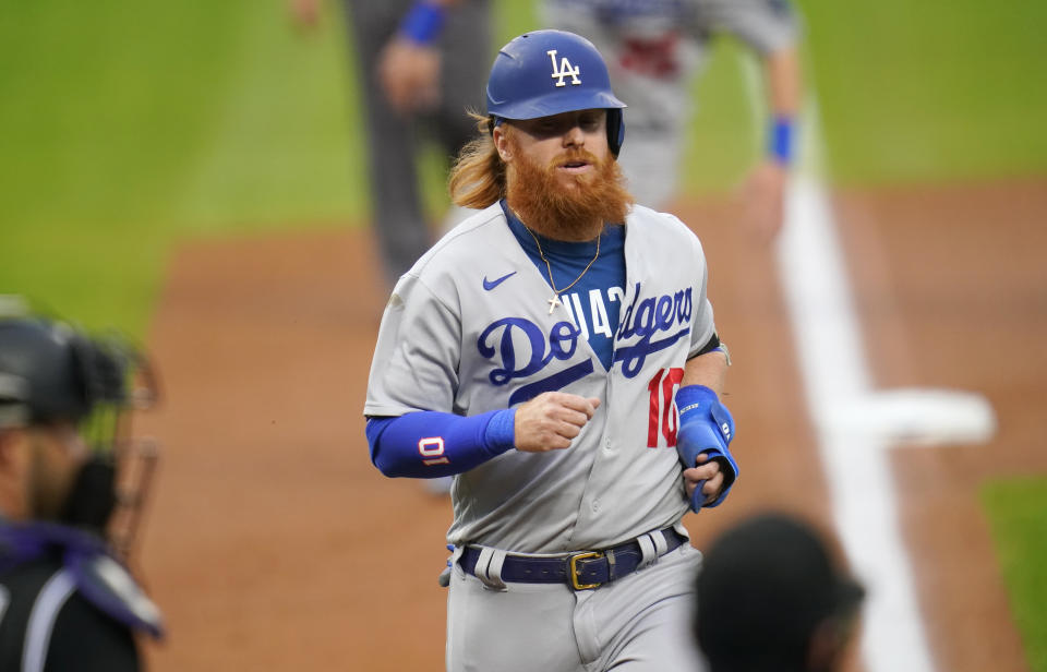 Los Angeles Dodgers' Justin Turner nears home to score on a triple by Chris Taylor off Colorado Rockies starting pitcher Chi Chi Gonzalez during the first inning of a baseball game Saturday, Sept. 19, 2020, in Denver. (AP Photo/David Zalubowski)