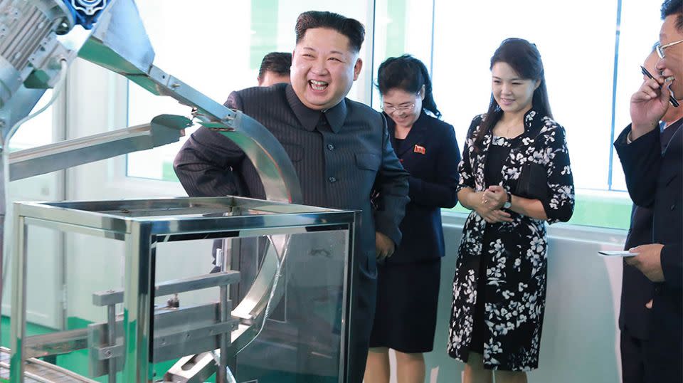The supreme leader was spotted giggling alongside his wife, Ri Sol Ju (second right) at a North Korean cosmetics factory. Source: Getty