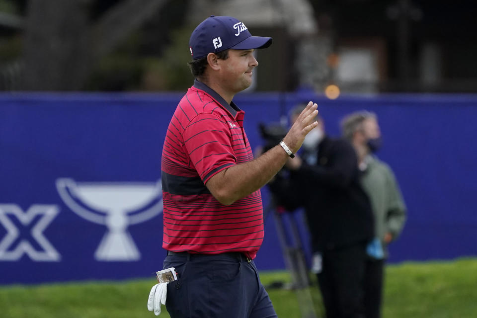 Patrick Reed waves after sinking his putt on the 18th hole on the South Course during the final round of the Farmers Insurance Open golf tournament at Torrey Pines, Sunday, Jan. 31, 2021, in San Diego. (AP Photo/Gregory Bull)