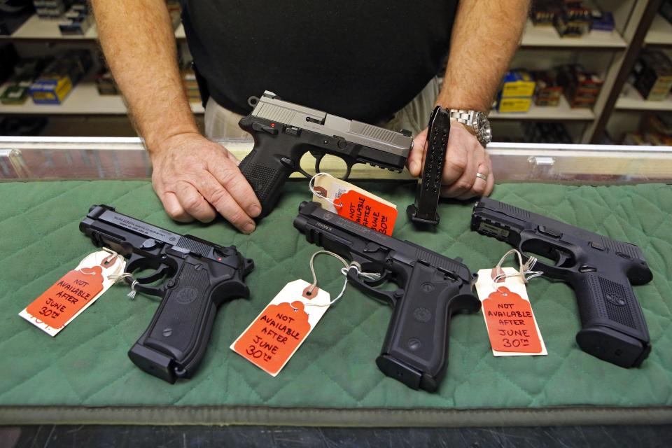 In this photo taken on June 27, 2013, Richard Taylor, manager of at Firing-Line gun store in Aurora, Colorado, showed some of the pistols that he could not sell after June 30 of that year because their magazines hold more than 15 rounds. Limits on ammunition magazines and universal background checks, signature pieces of Colorado Democrats' gun-control legislation in response to mass shootings, took effect July 1, 2013.