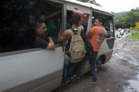 Honduran migrants get a free ride from a driver during their caravan to the U.S., in Chiquimula, Guatemala, Tuesday, Oct. 16, 2018. U.S. President Donald Trump threatened on Tuesday to cut aid to Honduras if it doesn't stop the impromptu caravan of migrants, but it remains unclear if governments in the region can summon the political will to physically halt the determined border-crossers. (AP Photo/Moises Castillo)