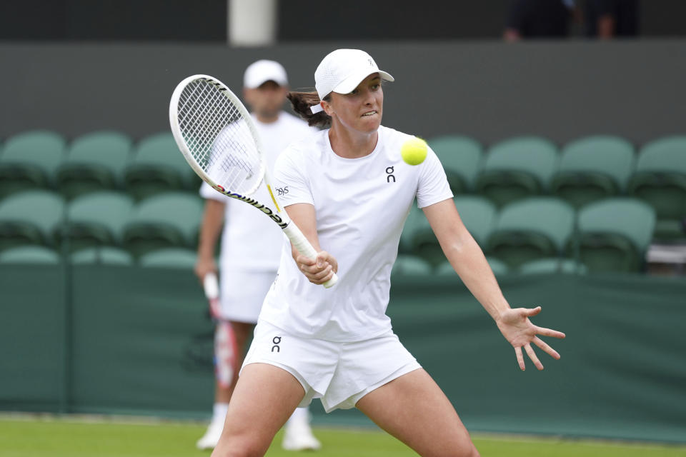 Poland's Iga Swiatek plays a volley on the practice court at the All England Lawn Tennis and Croquet Club ahead of the Wimbledon Championships, which begins on July 1st, in London, Friday June 28, 2024. (Zac Goodwin/PA via AP)