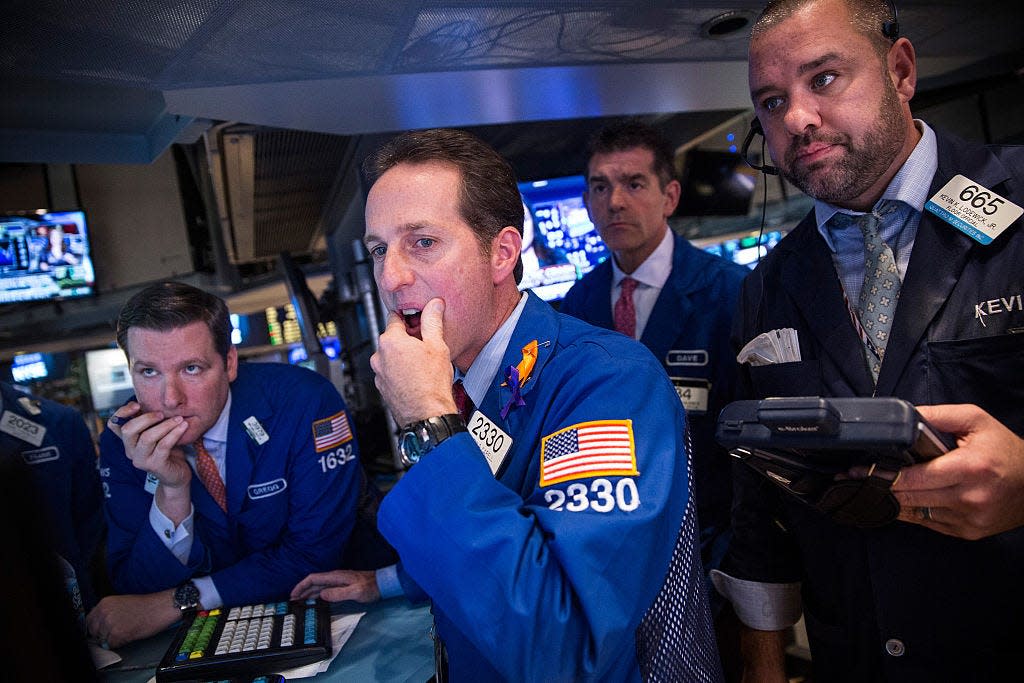 Traders work on the floor of the New York Stock Exchange