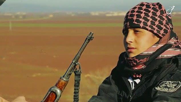 The boy, identified as Abu Imara al Omri, is seen saying his final goodbyes before donning a weapon and being groomed for his mission by another Islamic State militant. Photo: YouTube