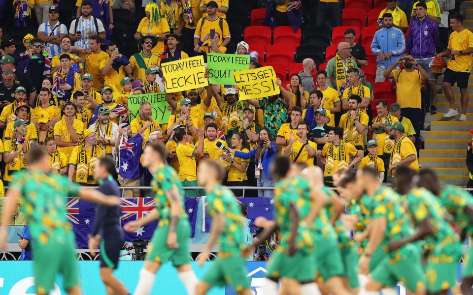 Fans of Australia cheer as their players warm up for the FIFA World Cup 2022 round of 16 soccer match between Argentina and Australia at Ahmad bin Ali Stadium in Doha - Shutterstock