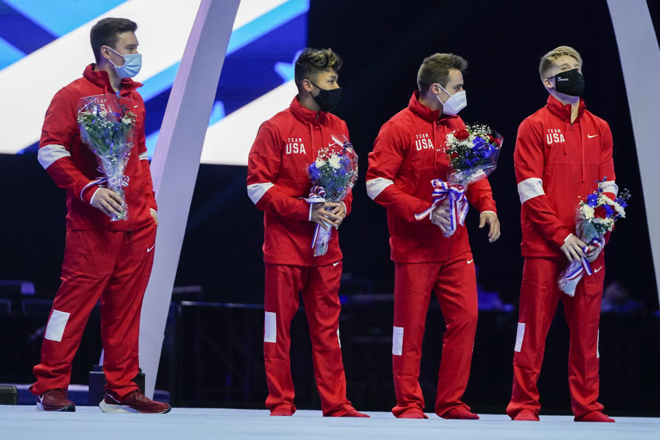 Members of the US Men's Olympic Team, Brody Malone, Yul Moldauer, Sam Mikulak and Shane Wiskus (L-R) stand 0 stage after the men's U.S. Olympic Gymnastics Trials Saturday, June 26, 2021, in St. Louis. (AP Photo/Jeff Roberson)