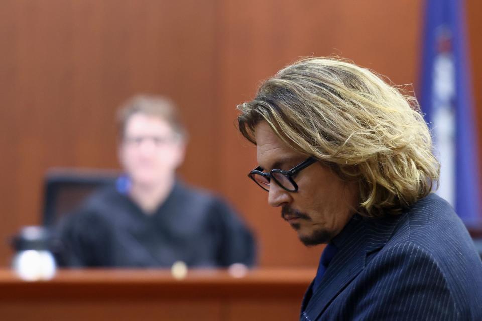 Judge Penney Azcarate (background) is presiding over dueling defamation lawsuits that Johnny Depp (front) is fighting with ex-wife Amber Heard.