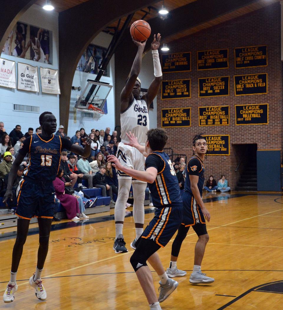 St. Maria Goretti's Caleb Embeya shoots a jump shot.