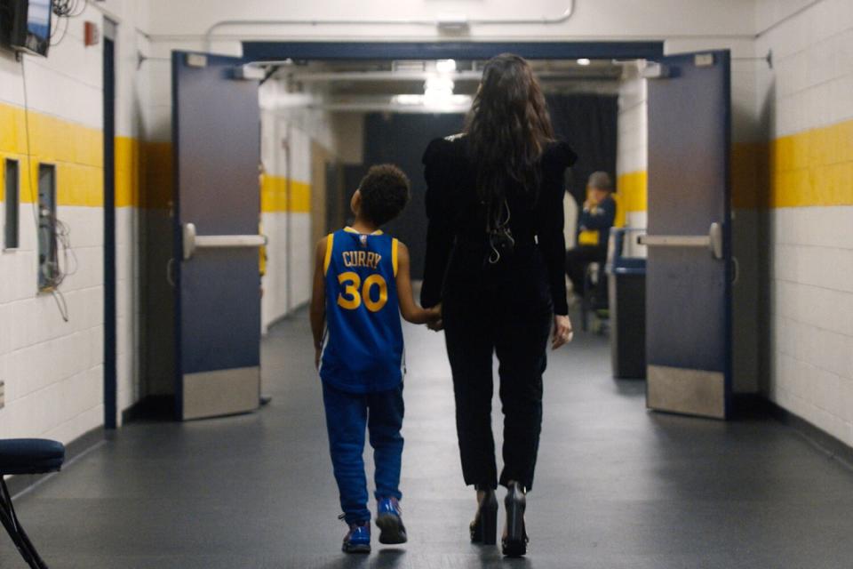 Idina Menzel walks backstage with her son. Tony AwardÆ-winning actress and singer Idina Menzel takes audiences on an intimate journey into her life on and off the stage in the new Disney+ documentary "Idina Menzel: Which Way to the Stage?" from Disney Branded Television. (Credit: Disney+)