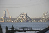 A crane is seen near the wreckage of the Francis Scott Key Bridge on Friday, March 29, 2024 in Baltimore. A cargo ship rammed into the major bridge in Baltimore early Tuesday, causing it to collapse in a matter of seconds. (AP Photo/Steve Ruark)