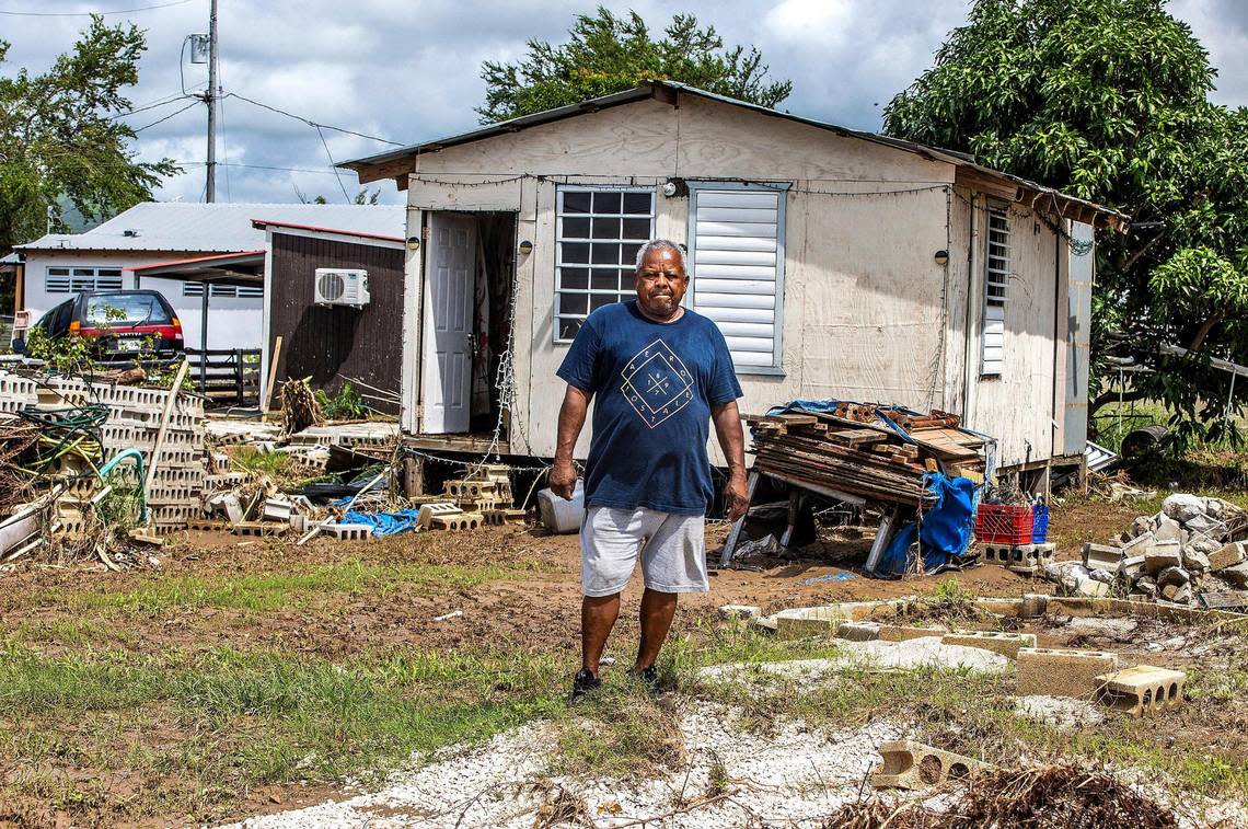 Gilberto Pacheco Padilla, 65, stands in front of his wrecked wooden house after Hurricane Fiona flooded Villa Esperanza in Salinas, Puerto Rico, on Friday Sept. 23, 2022.