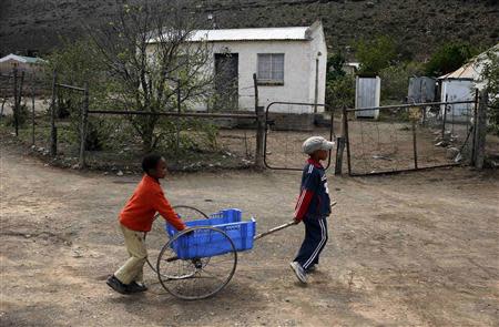 Children play in an impoverished township on the outskirts of Nieu-Bethesda in the Karoo October 26, 2013. REUTERS/Mike Hutchings