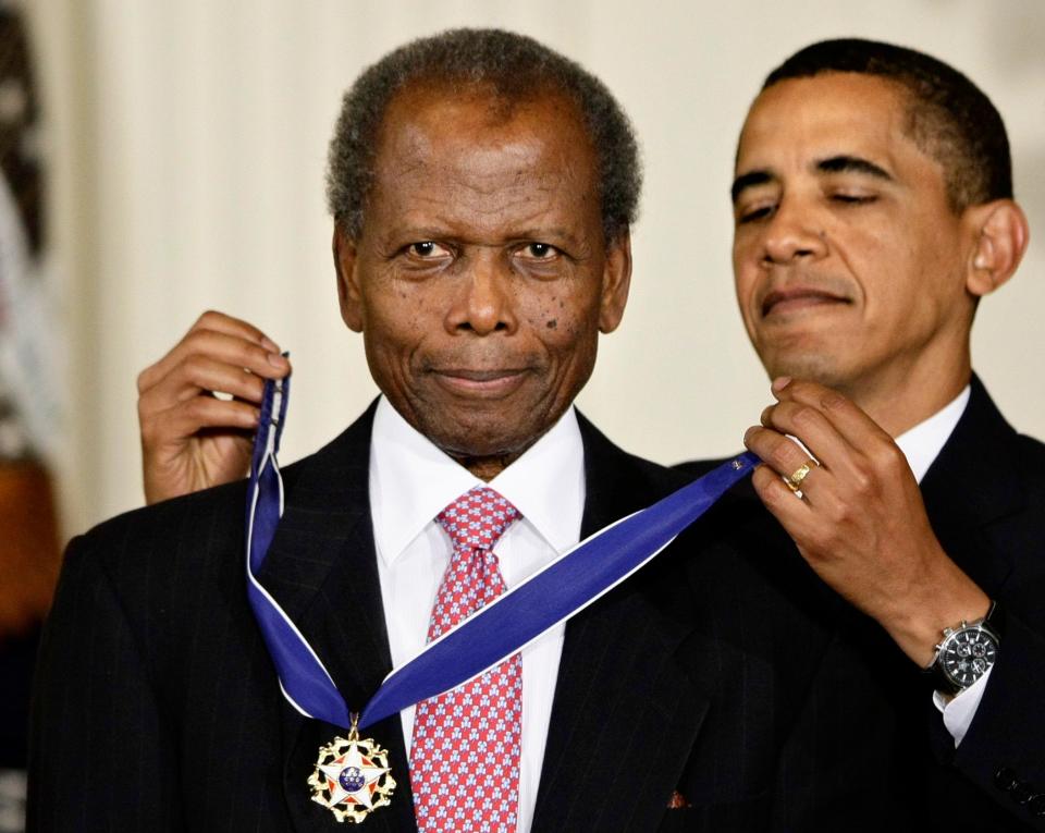 Former President Barack Obama presents the 2009 Presidential Medal of Freedom to Sidney Poitier during ceremonies in the East Room at the White House in Washington on Aug. 12, 2009.