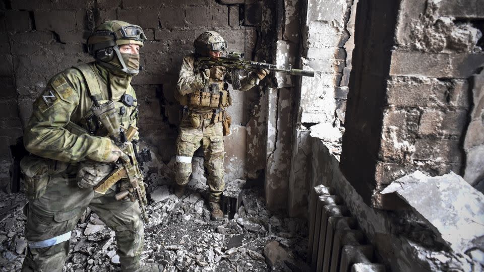 Russian soldiers patrol Mariupol's drama theater, southeastern Ukraine, in March 2022. - Alexander Nemenov/AFP/Getty Images