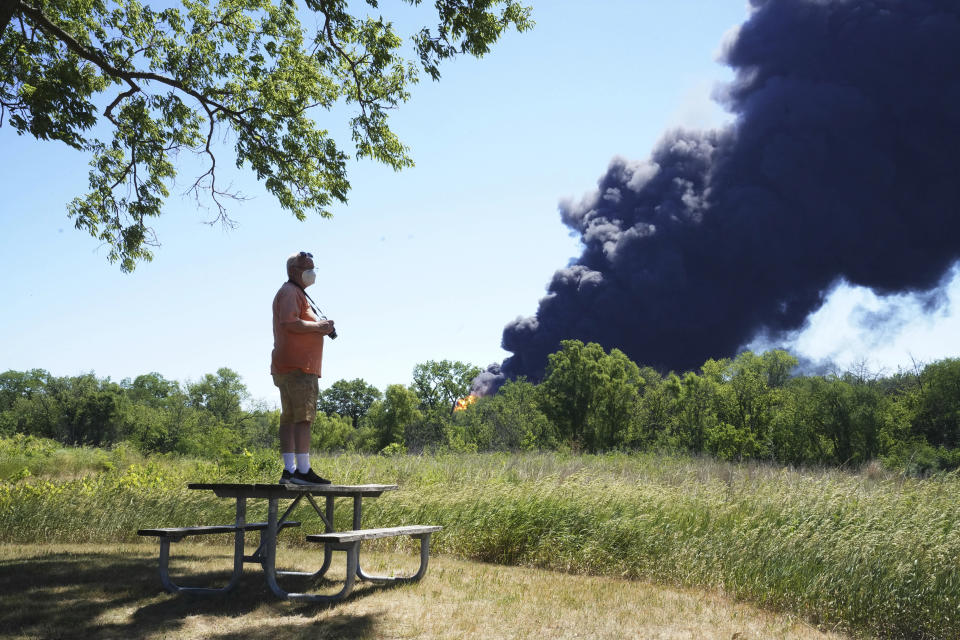 Neal Nuber, of South Beloit, Ill., watches the smoke billowing from a chemical plant fire in Rockton, Ill., Monday, June 14, 2021. (Stacey Wescott/Chicago Tribune via AP)