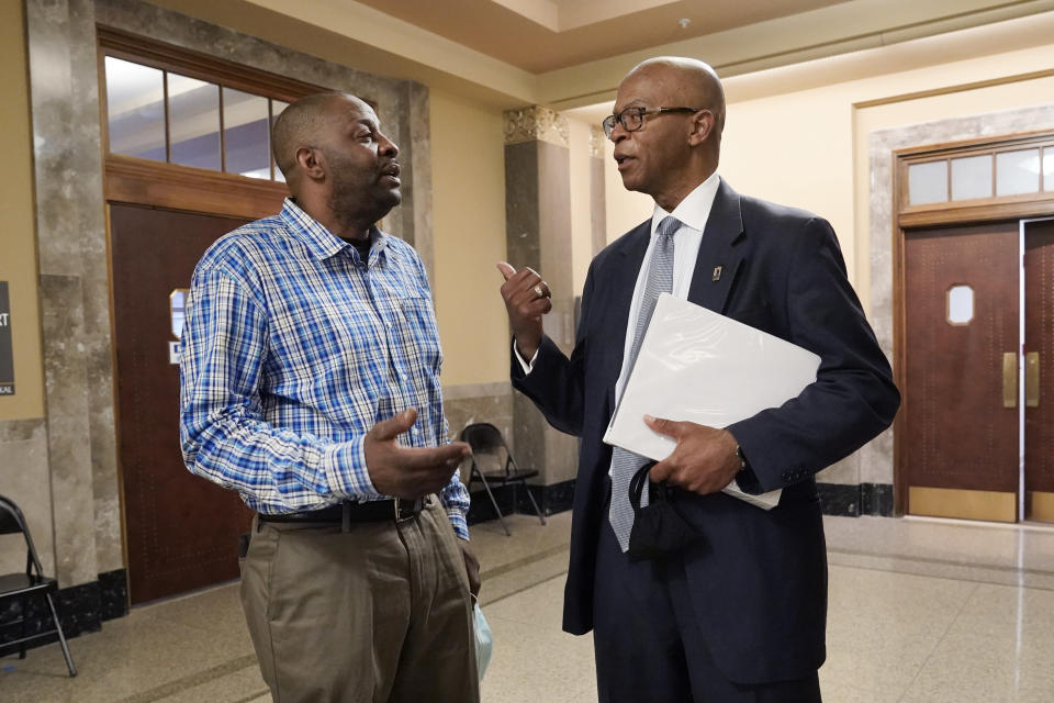 Emmit Gooden, left, mayor of Mason, Tenn., talks with attorney Terry Clayton after a hearing in Davidson County Chancery Court on Wednesday, April 6, 2022, in Nashville, Tenn. Clayton is representing the town leaders of Mason, a small town facing a takeover of its finances by the state comptroller. (AP Photo/Mark Humphrey)