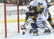 Pittsburgh Penguins right wing Rickard Rakell (67) is stopped by Toronto Maple Leafs goalie Erik Kallgren (50) during the second period of an NHL hockey game, Saturday, Nov. 26, 2022, in Pittsburgh. (AP Photo/Philip G. Pavely)