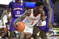 Houston guard Jamal Shead (1) works past a Northwestern State defender during the first half of an NCAA college basketball game Tuesday, Nov. 30, 2021, in Houston. (AP Photo/Justin Rex)