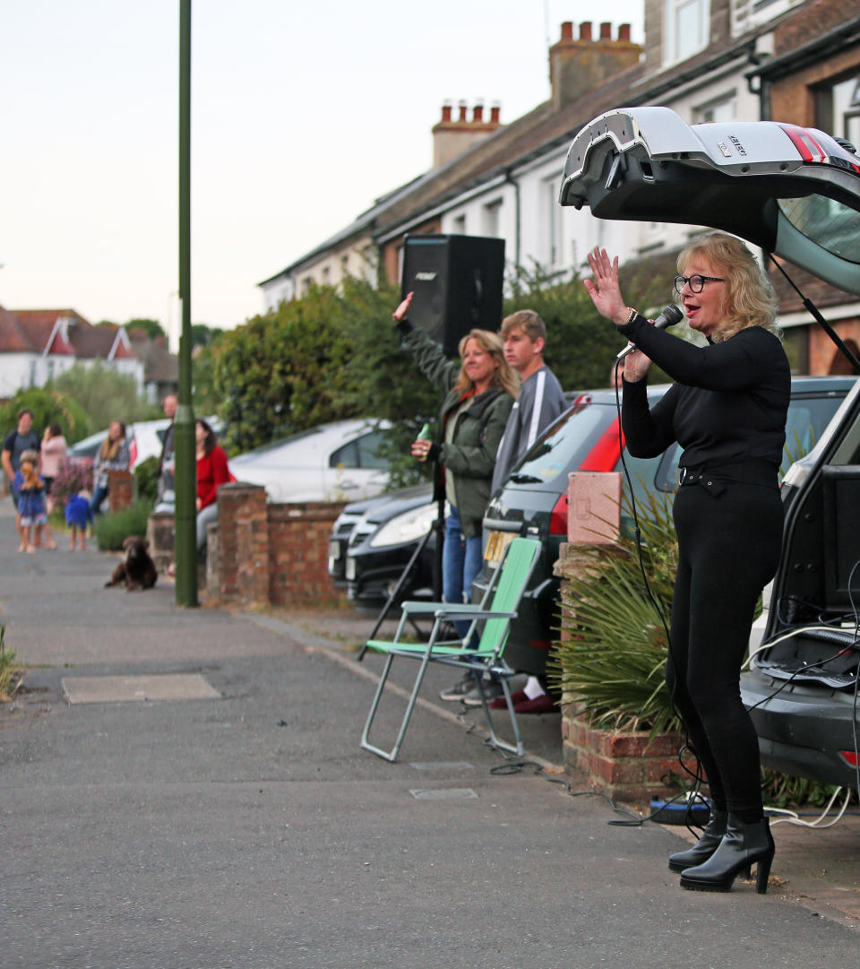 A woman, Tina Jane from Shoreham, sings songs out the back of her car to entertain the people that live on her street after the Clap for Carers, as the UK continues to ease out of lockdown to curb the spread of coronavirus.