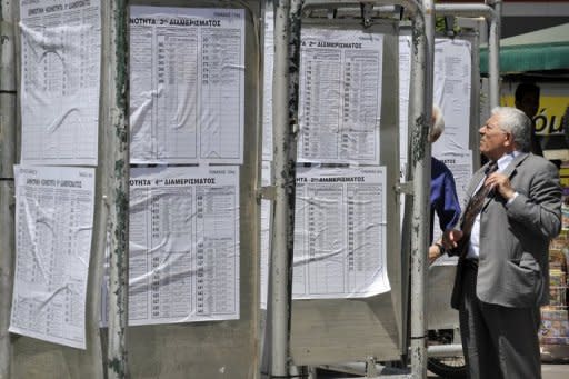 People are seen checking the lists of the polling stations on the eve of the Greek general elections in Athens, on May 5. Greece readies for elections with voters angry about austerity cuts and uncertainty over whether a new government can be formed with a strong enough mandate to push through yet more reforms demanded by its international creditors