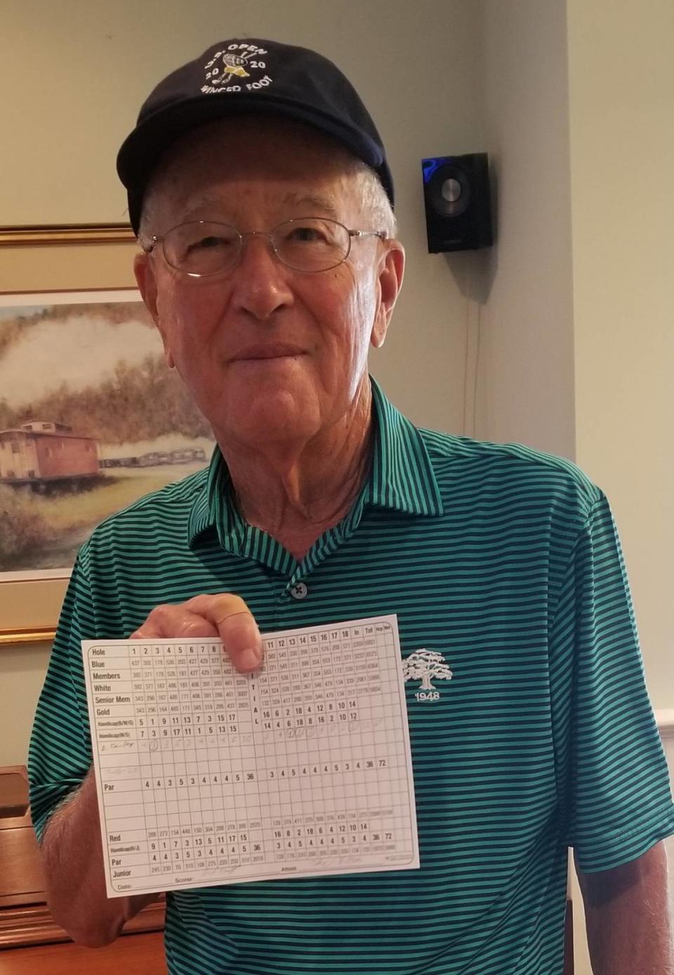 David Fairley, an 83-year-old amateur golfer from Charlotte, holds a scorecard from a day in which he shot a 67 over 18 holes earlier in 2020.