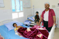 <p>A Yemeni man stands next to the bed of his child, wounded in an air strike by coalition forces the previous day on a bus at a market in rebel-held northern Yemen, at a hospital in the Yemeni city of Saada on Aug. 10, 2018. (Photo: Stringer/AFP/Getty Images) </p>