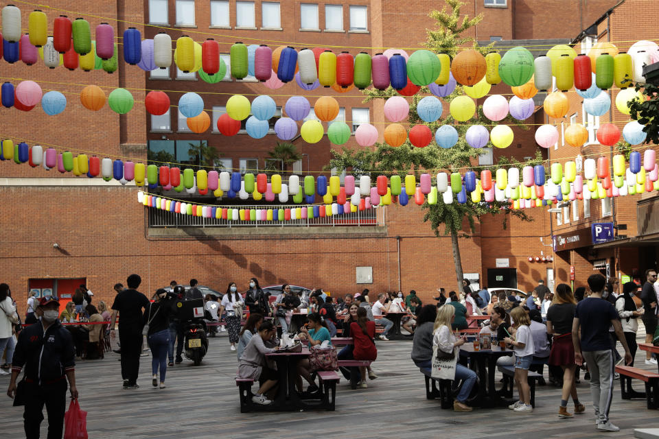 People sit outside on tables setup to reduce the spread of coronavirus so bars, cafes and restaurants can continue to stay open, in the Chinatown area of central London, Saturday, Sept. 19, 2020. Fresh nationwide lockdown restrictions in England appear to be on the cards soon as the British government targeted more areas Friday in an attempt to suppress a sharp spike in new coronavirus infections. (AP Photo/Matt Dunham)