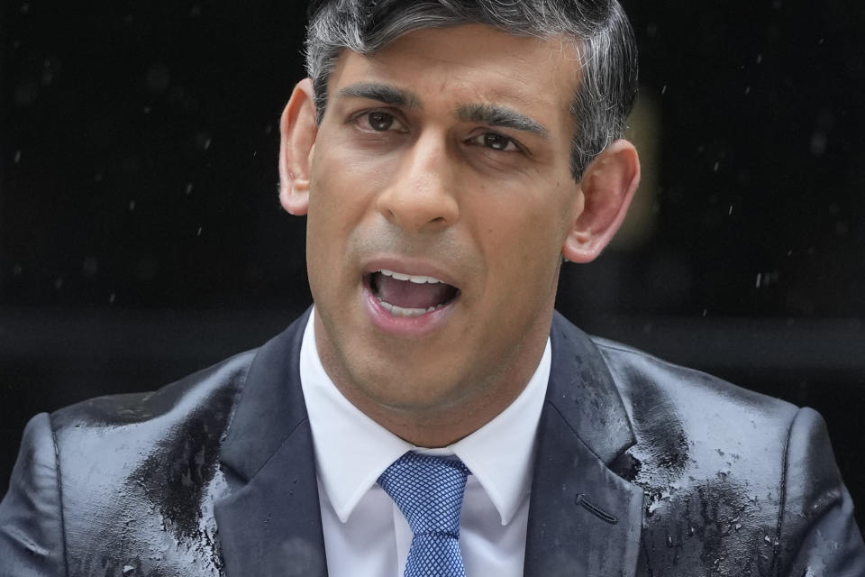 FILE - Britain's Prime Minister Rishi Sunak speaks to the media, as heavy rain falls, outside 10 Downing Street in London Wednesday, May 22, 2024, as he announces that he is to call a General Election for July 4. The United Kingdom will hold its first national election in almost five years on Thursday, with opinion polls suggesting that Prime Minister Rishi Sunak’s Conservative Party will be punished for failing to deliver on promises made during 14 years in power. (AP Photo/Kin Cheung, File)