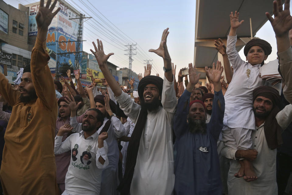 Supporters of Tehreek-e-Labaik Pakistan, a radical Islamist political party, chant religious slogans during a sit-in protest demanding the release of their leader, in Lahore, Pakistan, Thursday, Oct. 21, 2021. Thousands of Islamists are protesting in the eastern city of Lahore, demanding the release of their leader Saad Rizvi, who was arrested in April amid protest against France over depictions of Islam's Prophet Muhammad. (AP Photo/K.M. Chaudary)