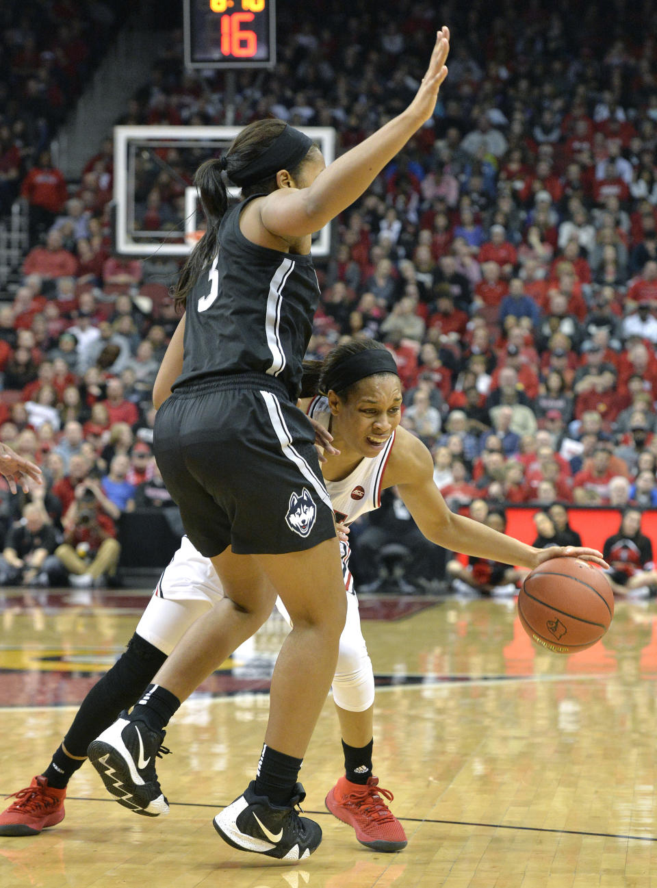 Louisville guard Asia Durr (25) attempts to get around Connecticut forward Megan Walker (3) during the second half of an NCAA college basketball game in Louisville, Ky., Thursday, Jan. 31, 2019. Louisville won 78-69. (AP Photo/Timothy D. Easley)