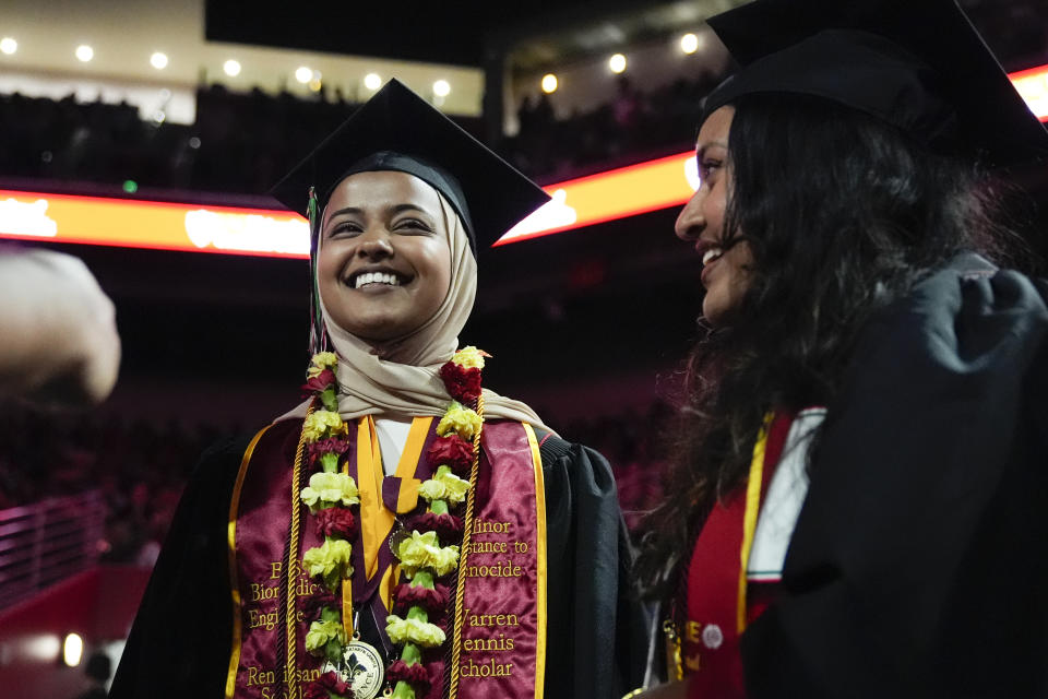 Asna Tabassum, left, stands in line during commencement for the University of Southern California's Viterbi School of Engineering Friday, May 10, 2024, in Los Angeles. (AP Photo/Ryan Sun)