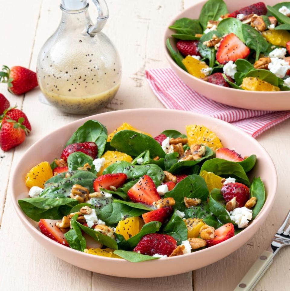 strawberry spinach salad in bowl with oranges