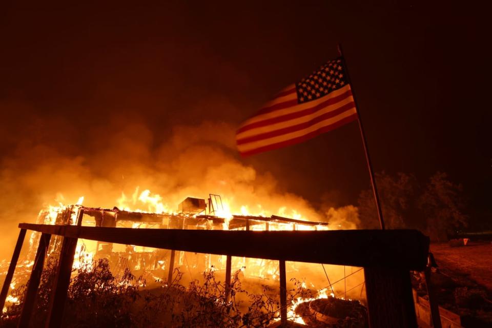 <div class="inline-image__caption"><p>A home burns near Mariposa, California.</p></div> <div class="inline-image__credit">Justin Sullivan/Getty</div>